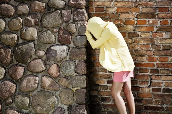 Depressed woman rests on the stone wall — Stock Photo, Image