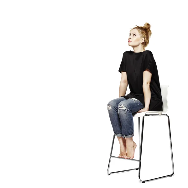 Portrait of a young woman sitting on modern chair — Stock Photo, Image
