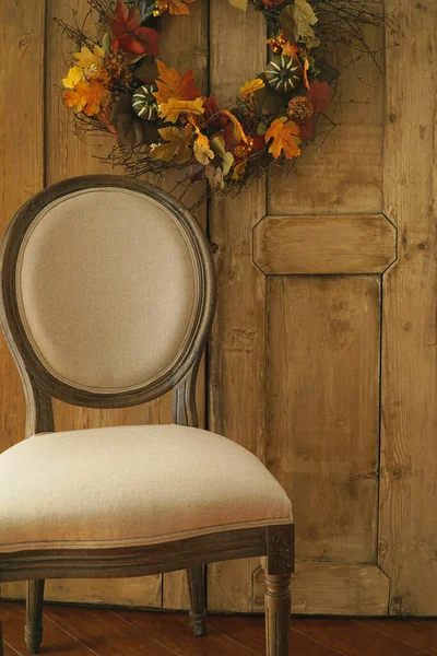 Designer chair with wreath on door