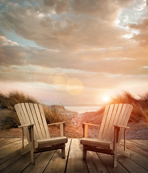 Wooden deck with chairs, sand dunes and ocean — Stock Photo, Image