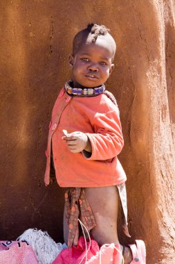 Himba child in native village clipart