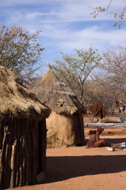 Himba woman in her village clipart