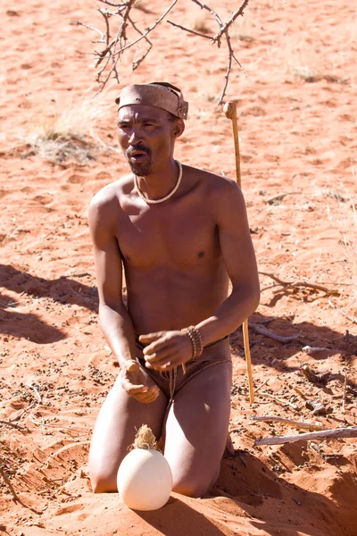 San man in native settlement — Stock Photo, Image