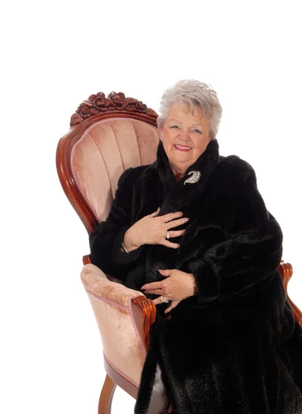 Senior woman sitting in armchair. — Stock Photo, Image