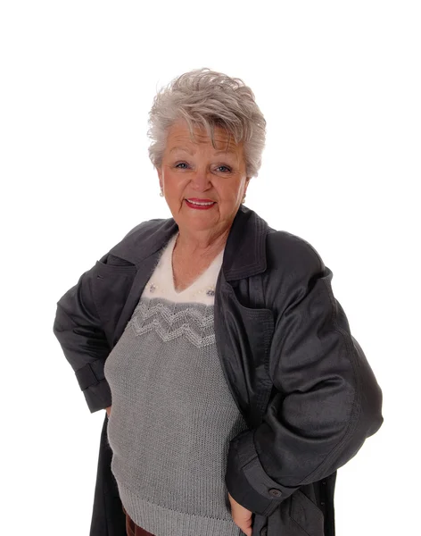 Senior woman standing in a coat. — Stock Photo, Image