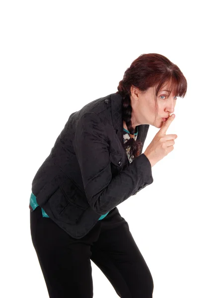 Middle age woman with finger over mouth. — Stock Photo, Image