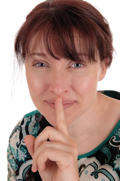 Lovely woman holding finger over mouth. — Stock Photo, Image