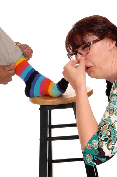 Woman smells the feet of husband. — Stock Photo, Image