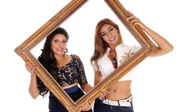 Two women holding picture frame. — Stock Photo, Image