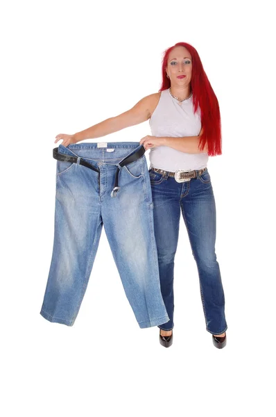 Woman holding big pants. — Stock Photo, Image