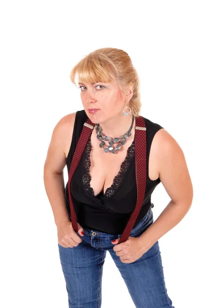 Pretty woman bending with suspenders. — Stock Photo, Image