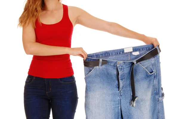 Woman holding big pants. — Stock Photo, Image