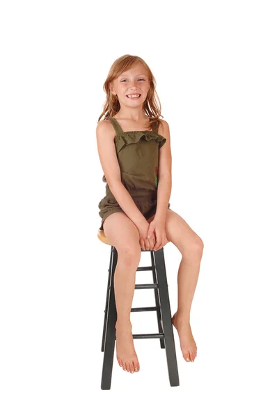 Girl sitting on high chair. — Stock Photo, Image