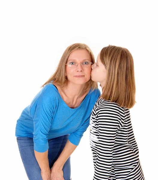 Girl kissing her mom. Stock Photo