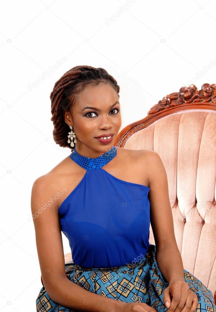 Portrait of African woman in armchair.