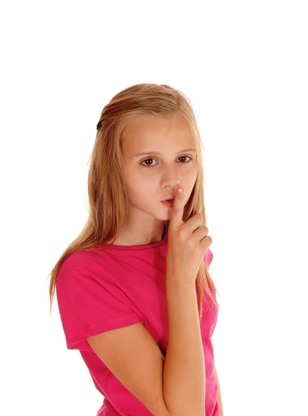 Pretty blond girl with finger over mouth. — Stock Photo, Image