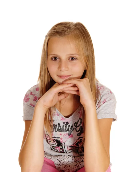 A sad looking young girl sitting on chair. — Stock Photo, Image