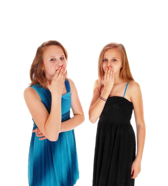 Two girls with hands over there mouth. — Stock Photo, Image