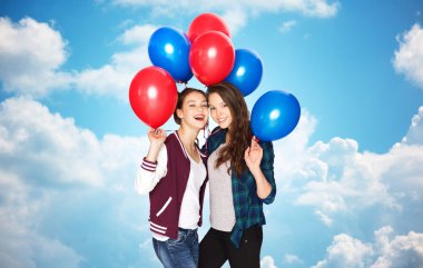 happy teenage girls with helium balloons over sky clipart