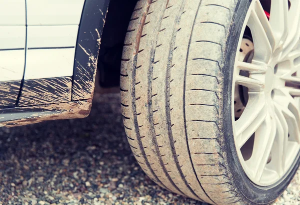 Close up of dirty car wheel on ground — Stock Photo, Image