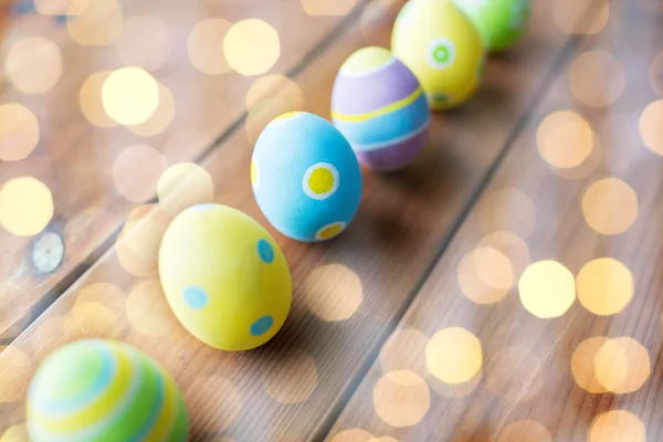 Close up of colored easter eggs on wooden surface — Stock Photo, Image