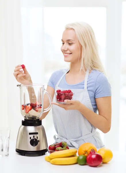 Usmívající se žena s mixérem příprava koktejl doma — Stock fotografie