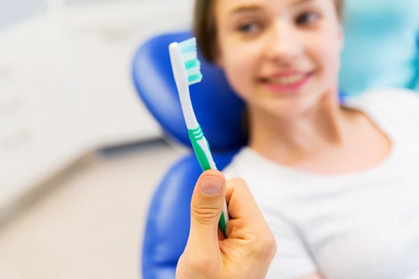 Close up of dentist hand with toothbrush and girl — Stock Photo, Image