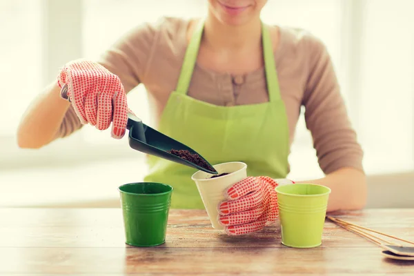 Close up of woman hands with trowel sowing seeds — Stock Photo, Image