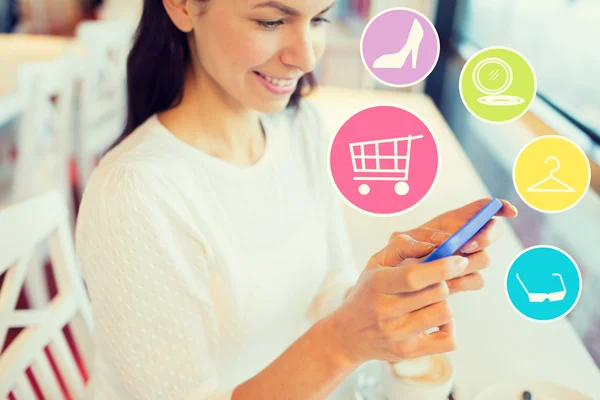 Smiling woman with smartphone shopping online — Stock Fotó