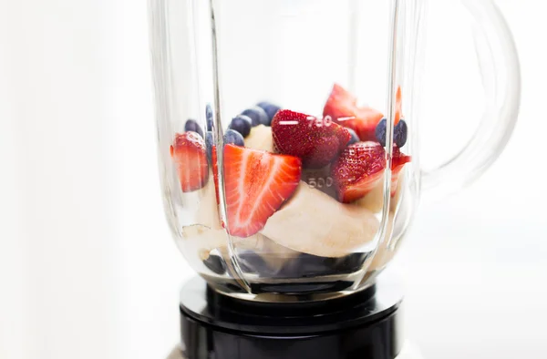 Close up of blender shaker with fruits and berries — Stock Photo, Image