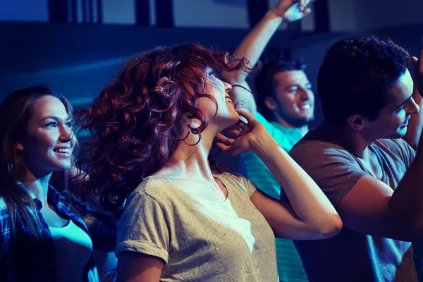 Happy friends dancing at night club — Stock Photo, Image