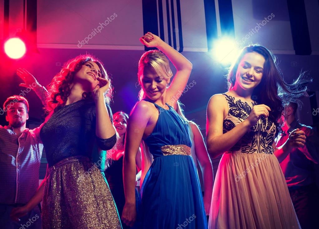 Smiling friends dancing in club — Stock Photo © Syda_Productions #101130994