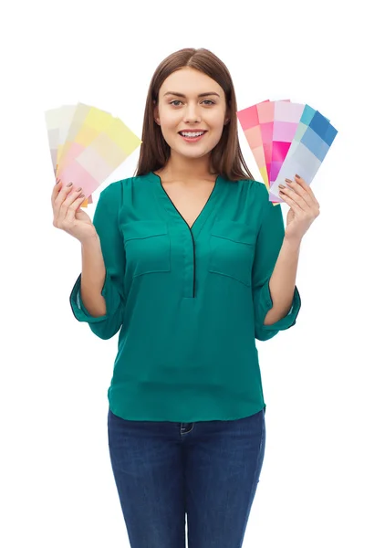 Smiling young woman with color swatches — Stock Photo, Image