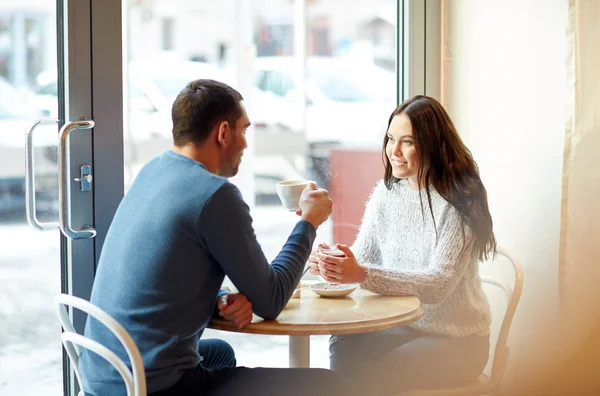 Happy couple drinking tea and coffee at cafe — Stock Photo, Image