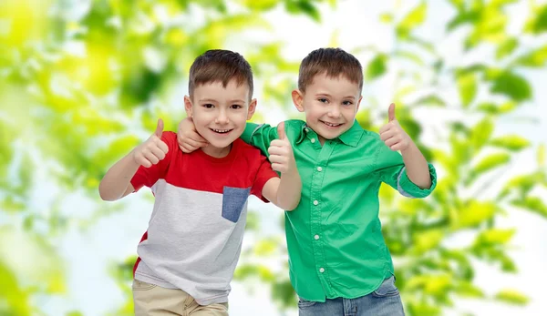 Happy smiling little boys showing thumbs up — Stock Photo, Image