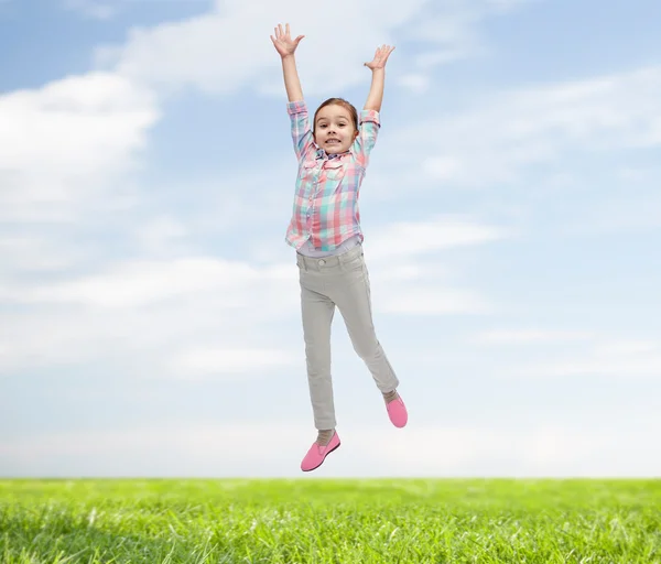 Happy little girl jumping in air — Stock Photo, Image