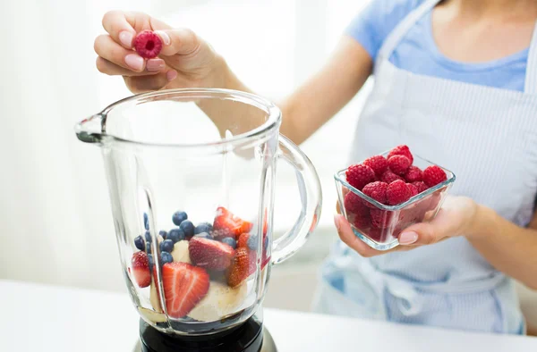 Close up of woman with blender making fruit shake — Stock Photo, Image