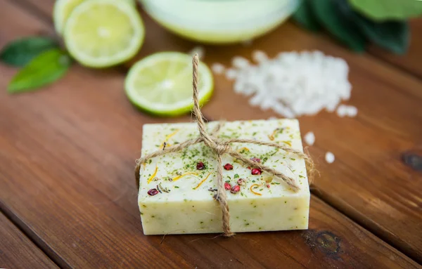 Close up of handmade herbal soap bar on wood — Stock Photo, Image