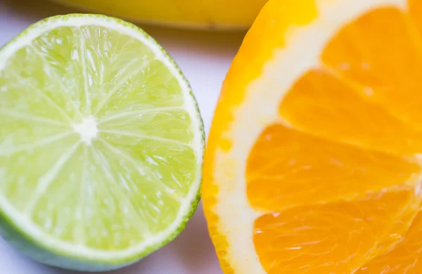 Close up of fresh juicy orange and lime — Stock Photo, Image