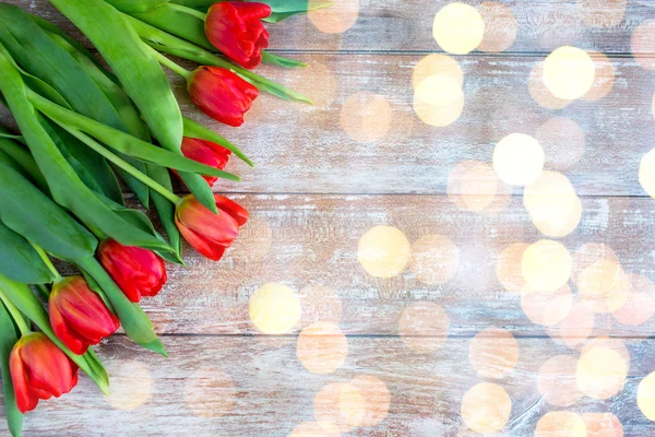 Close up of red tulips on wooden background — Stock Photo, Image