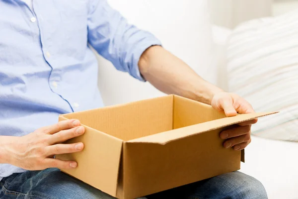 Close up of man with cardboard box parcel at home — Stock Photo, Image