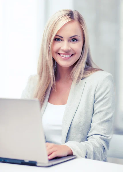 Businesswoman with laptop in office — Stock Photo, Image