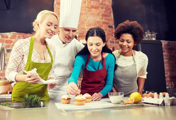 Happy women and chef cook baking in kitchen — Stock Photo, Image