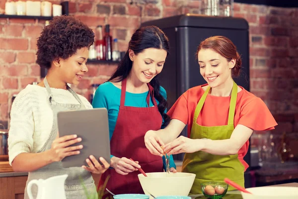 Happy women with tablet pc in kitchen — Stock Photo, Image