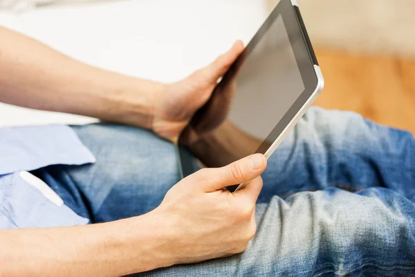 Close up of man working with tablet pc at home — Stock Photo, Image