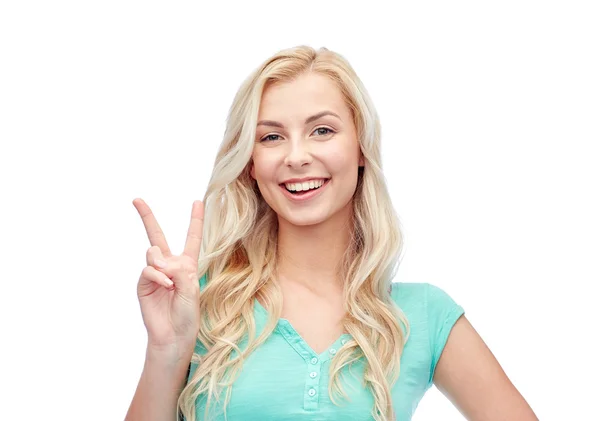 Smiling young woman or teenage girl showing peace Royalty Free Stock Photos