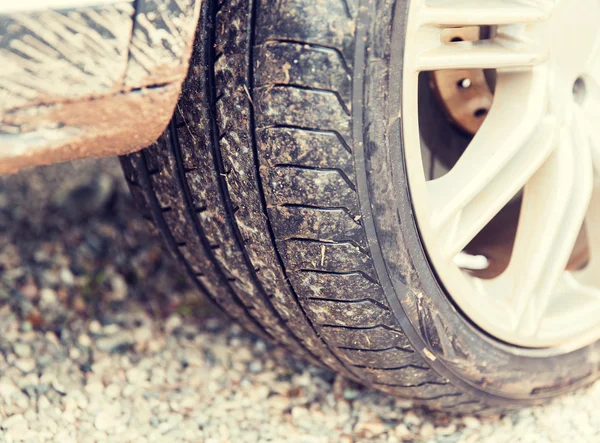 Close up of dirty car wheel on ground — Stock Photo, Image