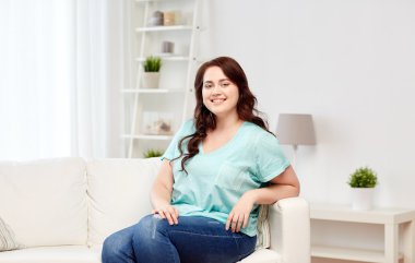 happy young plus size woman at home clipart