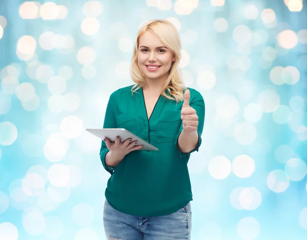 Smiling woman with tablet pc showing thumbs up — Stock Photo, Image