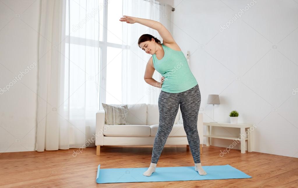 woman exercising on mat at home Photo by ©Syda_Productions 101938986